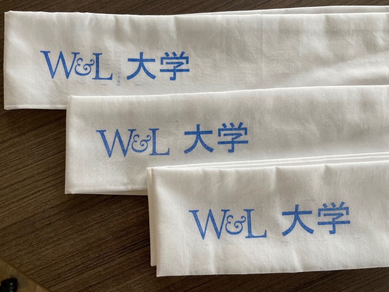 white Japanese hachimaki with rubber stamped text in blue